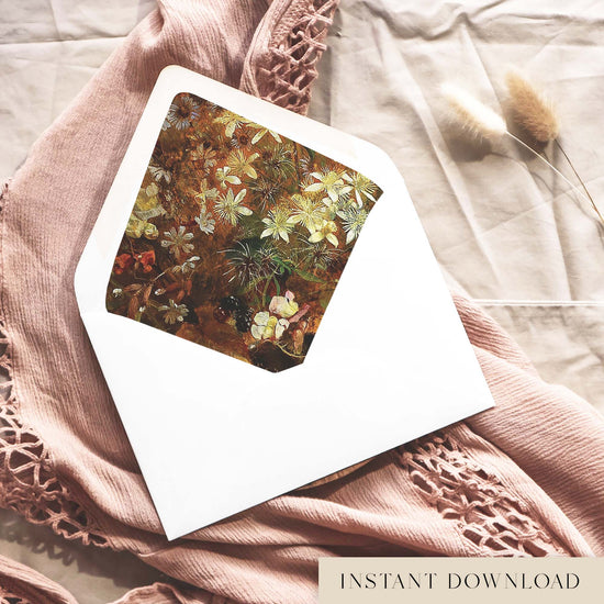 Printable vintage botanical envelope liner for 5x7 wedding invitations, with a painted wildflower design in rust brown, cream and olive green, shown inside a white envelope on dusty pink fabric.
